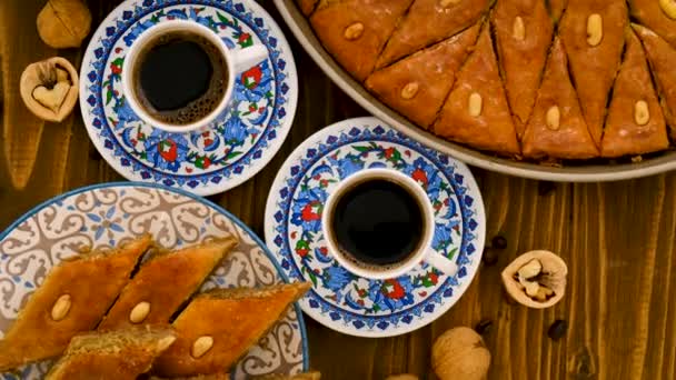 Baklava and Turkish coffee on the table. Selective focus. — Stock Video