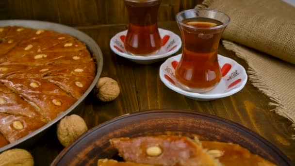 Baklava and Turkish tea on the table. Selective focus. — Stock Video