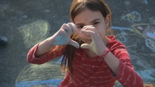 Children draw with chalk on asyalte. Selective focus. — Wideo stockowe