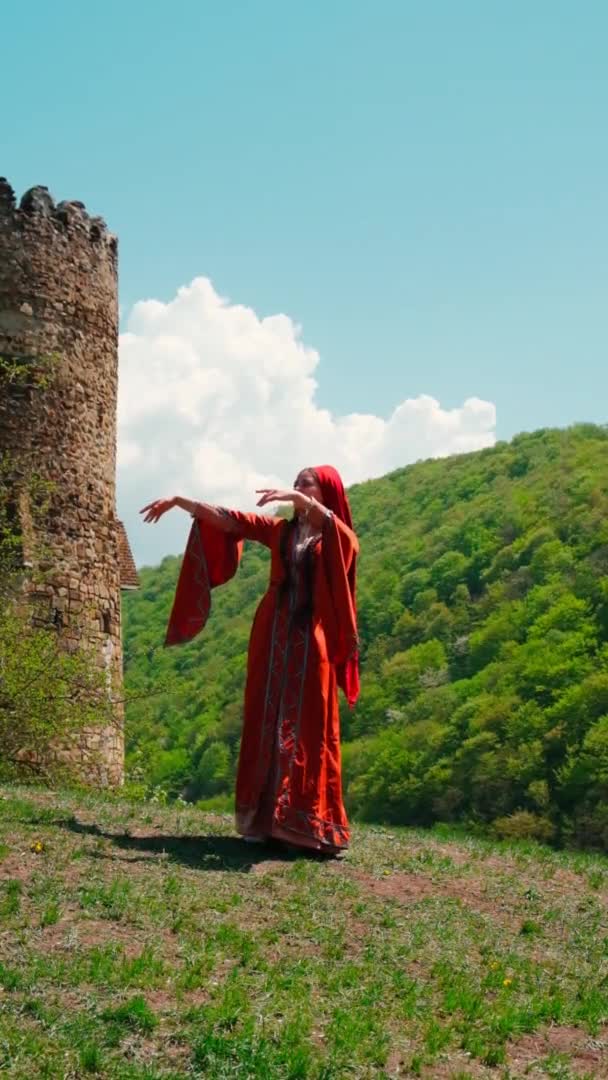 A girl in a national Georgian red dress is dancing. Selective focus. — Vídeo de Stock