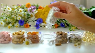 Homeopathy and dietary supplements with medicinal herbs. Selective focus. Nature.