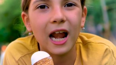 A child eats ice cream in the park. Selective focus. Kid.