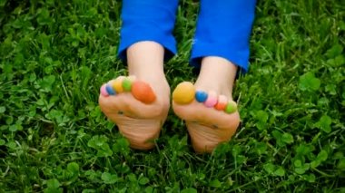 Child on the grass feet paint drawing. Selective focus. Kid.