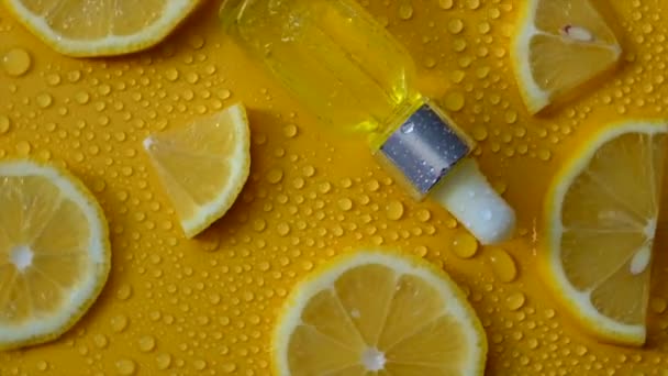 Lemon Essential Oil Yellow Background Water Drops Selective Focus Food — ストック動画