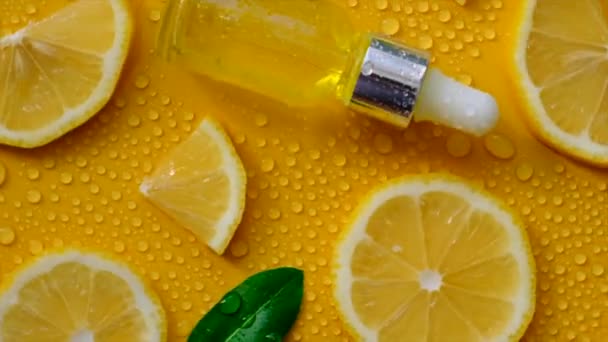 Lemon Essential Oil Yellow Background Water Drops Selective Focus Food — Stockvideo
