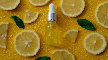 Sarı zemin üzerinde limon yağı ve su damlaları. Seçici odaklanma. Yiyecek..