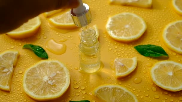 Lemon Essential Oil Yellow Background Water Drops Selective Focus Food — стоковое видео