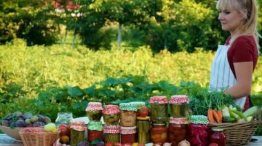 A woman is preserving vegetables. Selective focus. People.