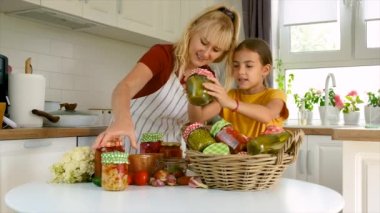 Woman with jar preserved vegetables for winter mother and daughter. Selective focus.