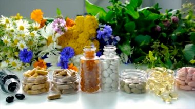 Homeopathy and dietary supplements with medicinal herbs. Selective focus. Nature.