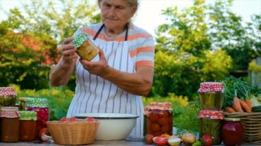 Senior woman makes preservation of vegetables. Selective focus. People.