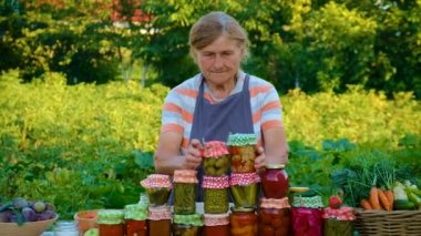 Senior woman makes preservation of vegetables. Selective focus. People.