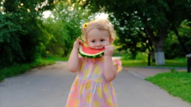 The child eThe child eats watermelon in summer. Selective focus.ats watermelon in summer. Selective focus. Kid.