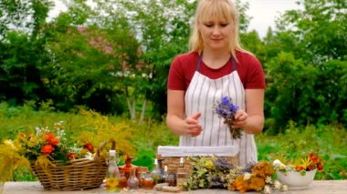 Woman makes tincture with medicinal herbs. Selective focus. Nature.