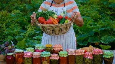Senior woman makes preservation of vegetables. Selective focus. People.