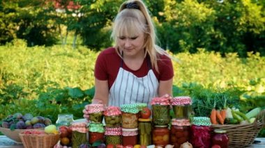 A woman is preserving vegetables. Selective focus. People.
