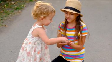 The child is playing with the frog. Selective focus. Kid.