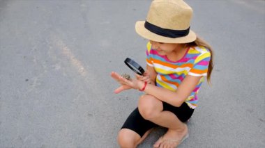 The child is playing with the frog. Selective focus. Kid.