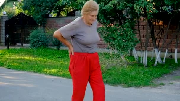 Grandmother Hurts Her Back Road Selective Focus Nature — Vídeos de Stock
