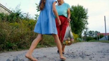 Children and grandmother carry vegetables in a bag. Selective focus. Food.
