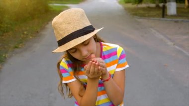 The child is playing with the frog. Selective focus. Kid.