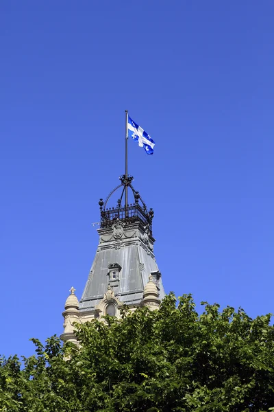 Quebec Flag over tower in trees, Canada