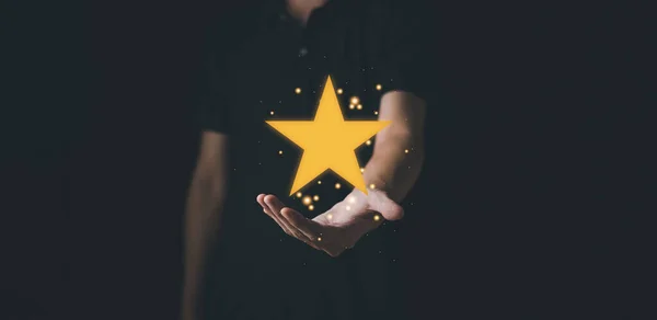 Star rating on hand man. Customer evaluation feedback. Customer service evaluation and satisfaction and feedback survey concept for best excellent business rating experience.
