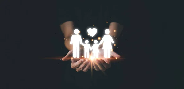 Man protect my family. Heart and family icon on hand. Family day concept.