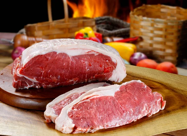 Beef sirloin steak against raw fillet