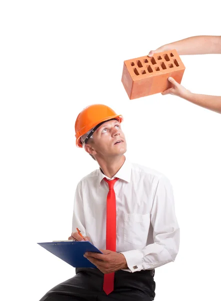 Empresário leva um tijolo — Fotografia de Stock