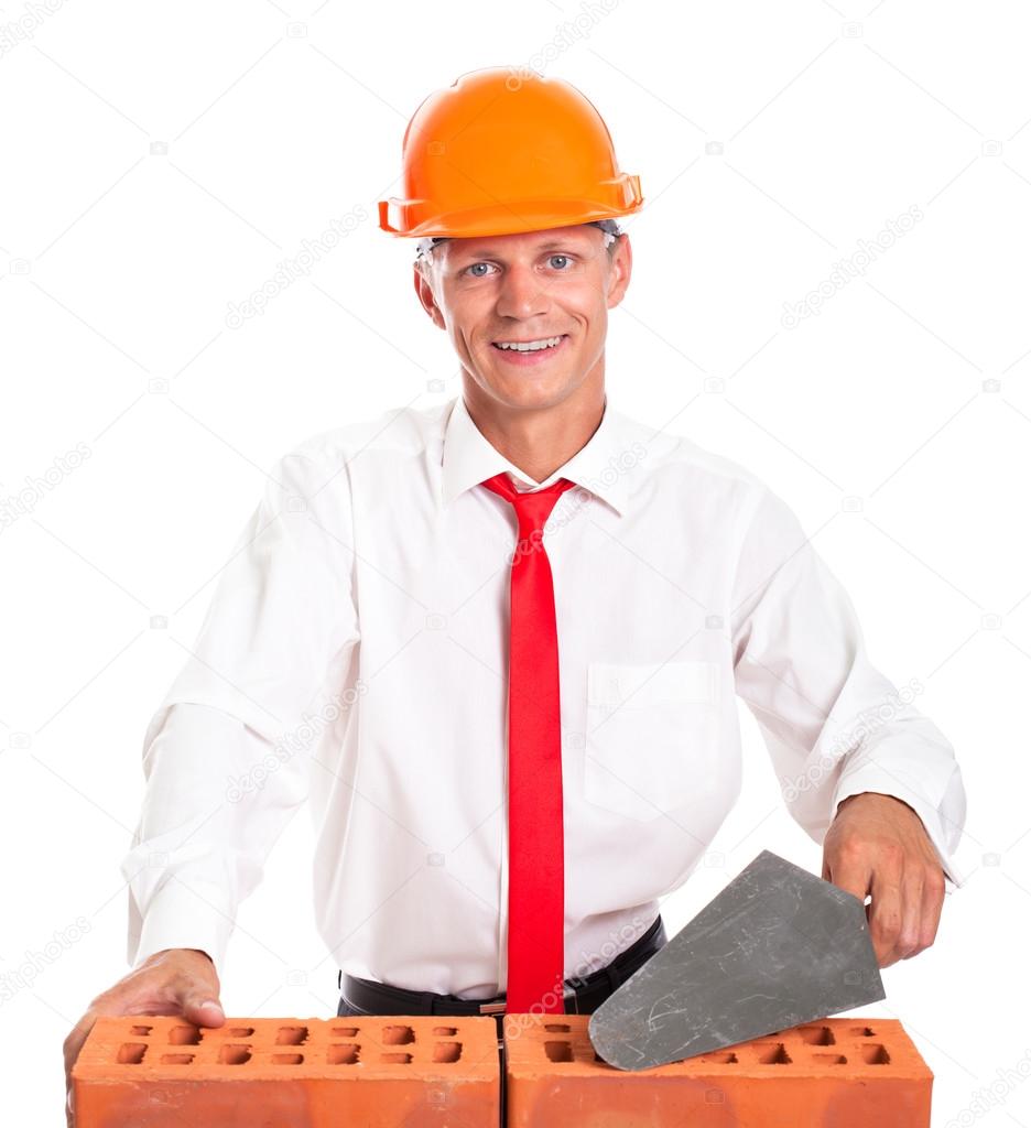 Businessman building a brick wall