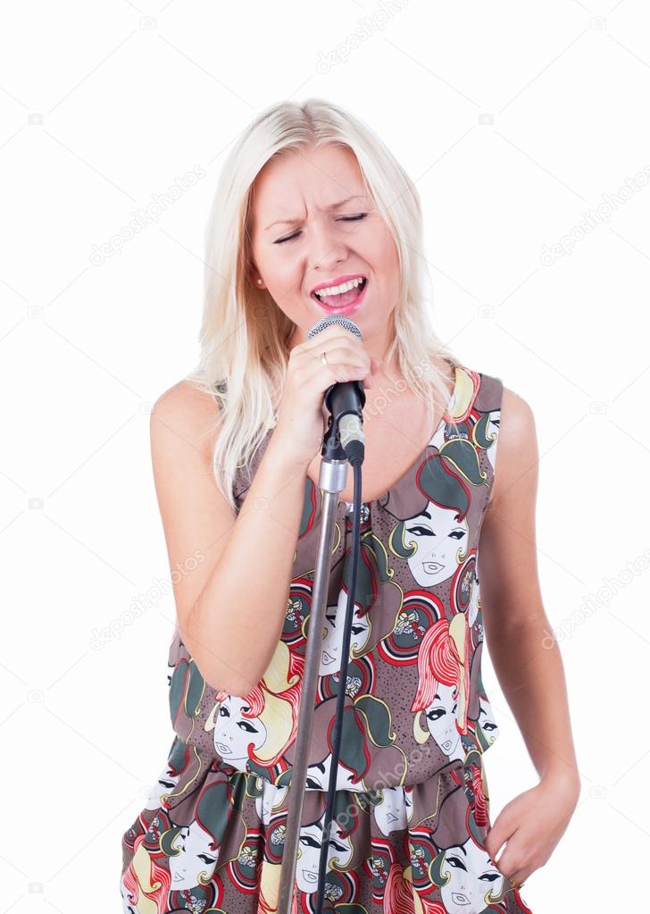 The girl singing into a microphone emotionally