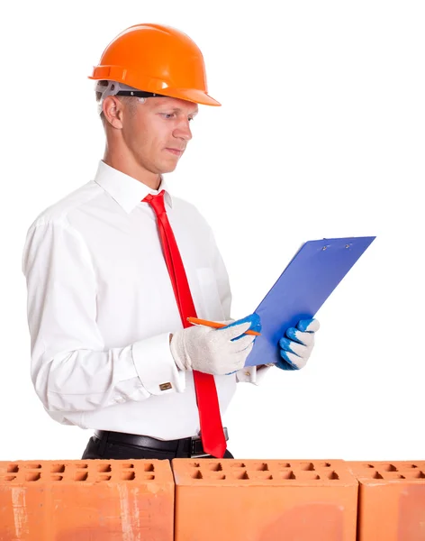 The businessman behind a brick wall and read a checklist — Stock Photo, Image