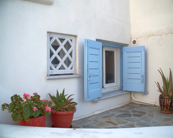 Blue window and flowerpots — Stock Photo, Image