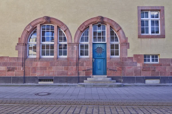 Entrance with arched blue door and windows — Stock Photo, Image