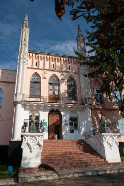 Cherniatyn, Ukraine - 16.08.2021: staircase with lion sculptures guard entrance door, coquina towers, west facade, polish noble Ignacy Witoslawski palace, sightseeing landmark