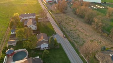 An Aerial View of Rural America of Amish Farmlands and a Horse and Buggy Traveling on a Country Road on a Sunny Spring Day