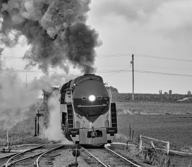 Black and White Antique Restored Steam Freight Train Approaching Blowing Smoke and Steam