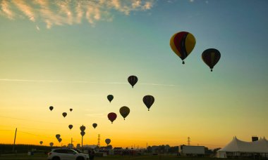 View of Many Hot Air Balloons Getting Ready to Take Off On An Early Morning