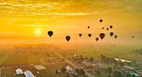 Aerial View of Many Hot Air Balloons Flying into the Sun and Mist On An Early Morning — Zdjęcie stockowe