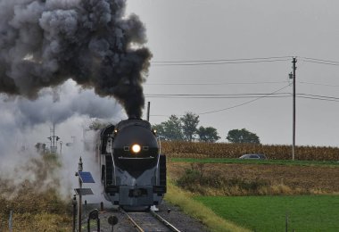 Antique Restored Steam Freight Train Approaching Blowing Smoke and Steam