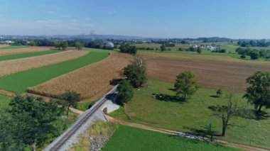Drone View of a Steam Engine Rounding a Curve Thru Farmlands in Slow Motion on a Sunny Day