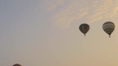 Bird in Hand, Pennsylvania, September 18, 2021 - Multiple Hot Air Balloons Floating By at Different Highs on a Golden Early Morning Launch of Many Balloons