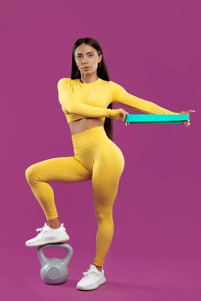 Sporty Young Woman Training Stretch Band Purple Background Holding One — Stock fotografie