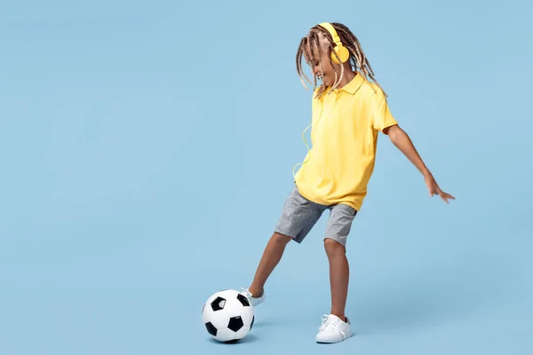 Sporty Little Boy African Dreads Shoot Soccer Ball Blue Background — 图库照片