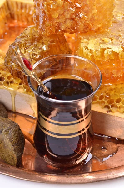Fresh honeycombs and wooden stick ,cup of Turkish tea,propolis — Stock Photo, Image