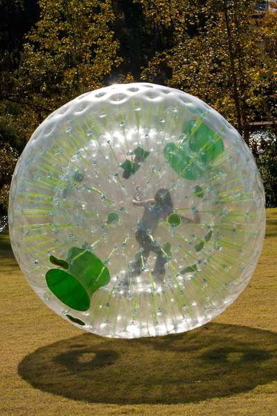 Girl Rolls Inside Large Zorb — Stock Photo, Image