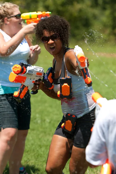 Woman Squirts In Group Water Gun Fight — Stock Photo, Image