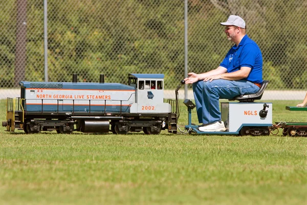 Man Operates Miniature Steam Engine Ride — Stock Photo, Image