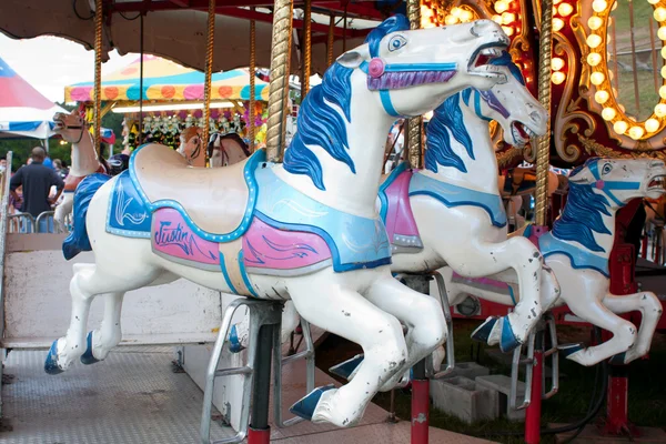 County fair carousel atlara closeup — Stok fotoğraf